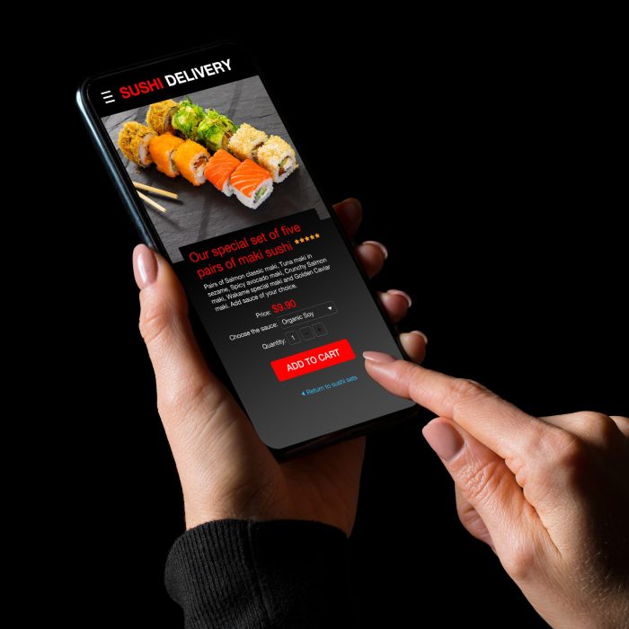 Woman ordering sushi on mobile phone for home delivery